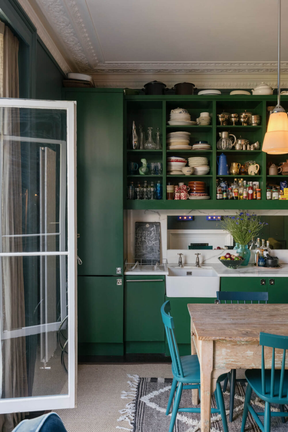 A Rich Color and Material Palette in a Small Victorian Apartment 7 green kitchen butler sink open cabinets