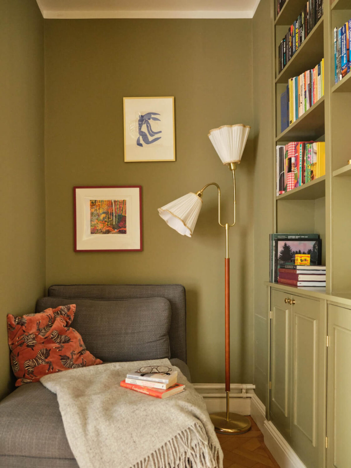 The Top Home Design Trends for 2026: Bold Color, Cozy Corners & Climate-Ready Living 11 green reading nook with built-in bookshelves