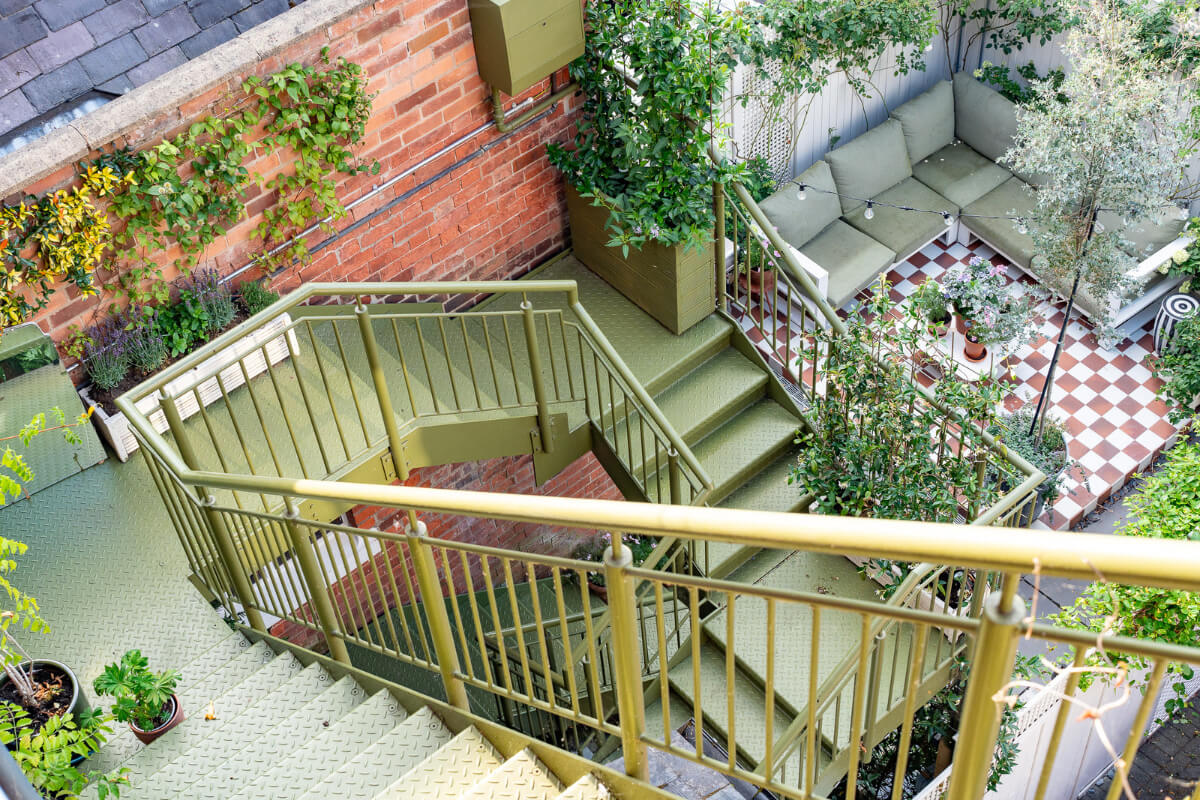 A Colorful Eclectic Victorian Maisonette Home in England 29 green staircase to garden