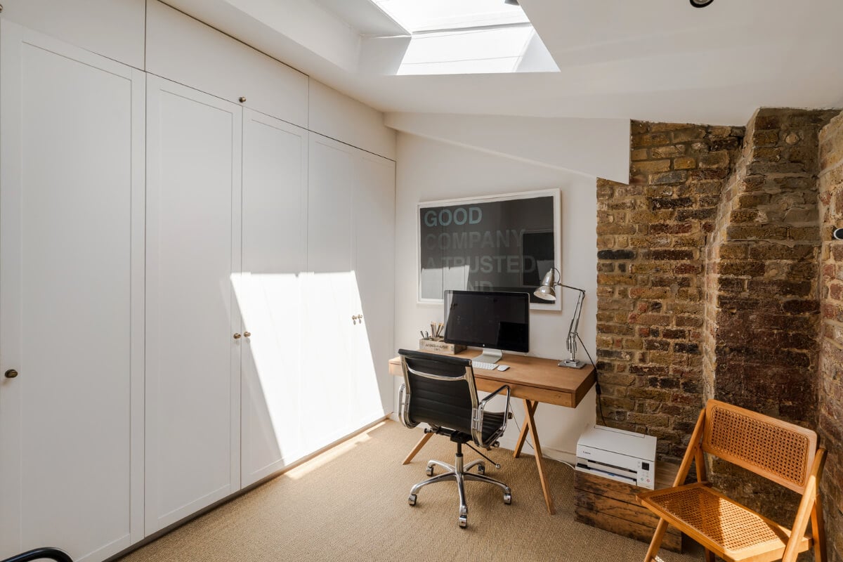 An Industrial Mews House with a Sebastian Cox deVOL Kitchen 22 home office built-in wardrobes exposed brick skylight