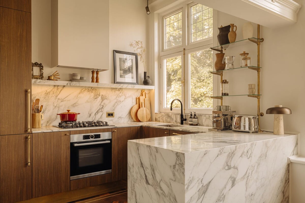 A Luxurious Parisian-Inspired Apartment in Amsterdam 9 kitchen with open storage marble island