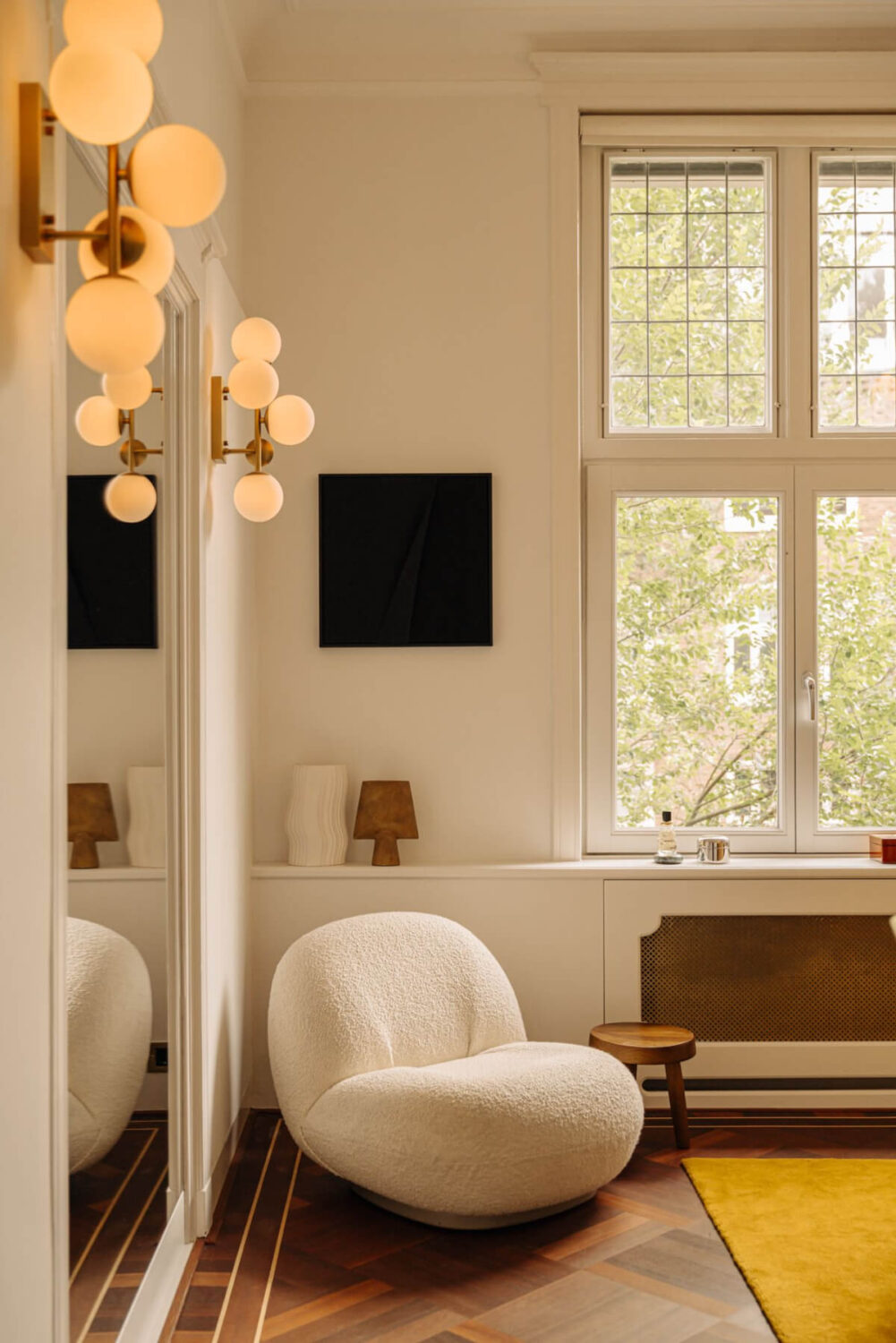 A Luxurious Parisian-Inspired Apartment in Amsterdam 17 parquet floor yellow rug