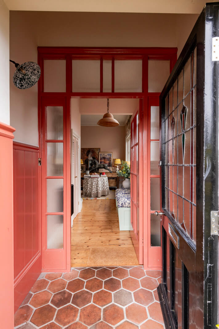A Colorful Eclectic Victorian Maisonette Home in England 13 pink hall paneling terracotta floor tiles