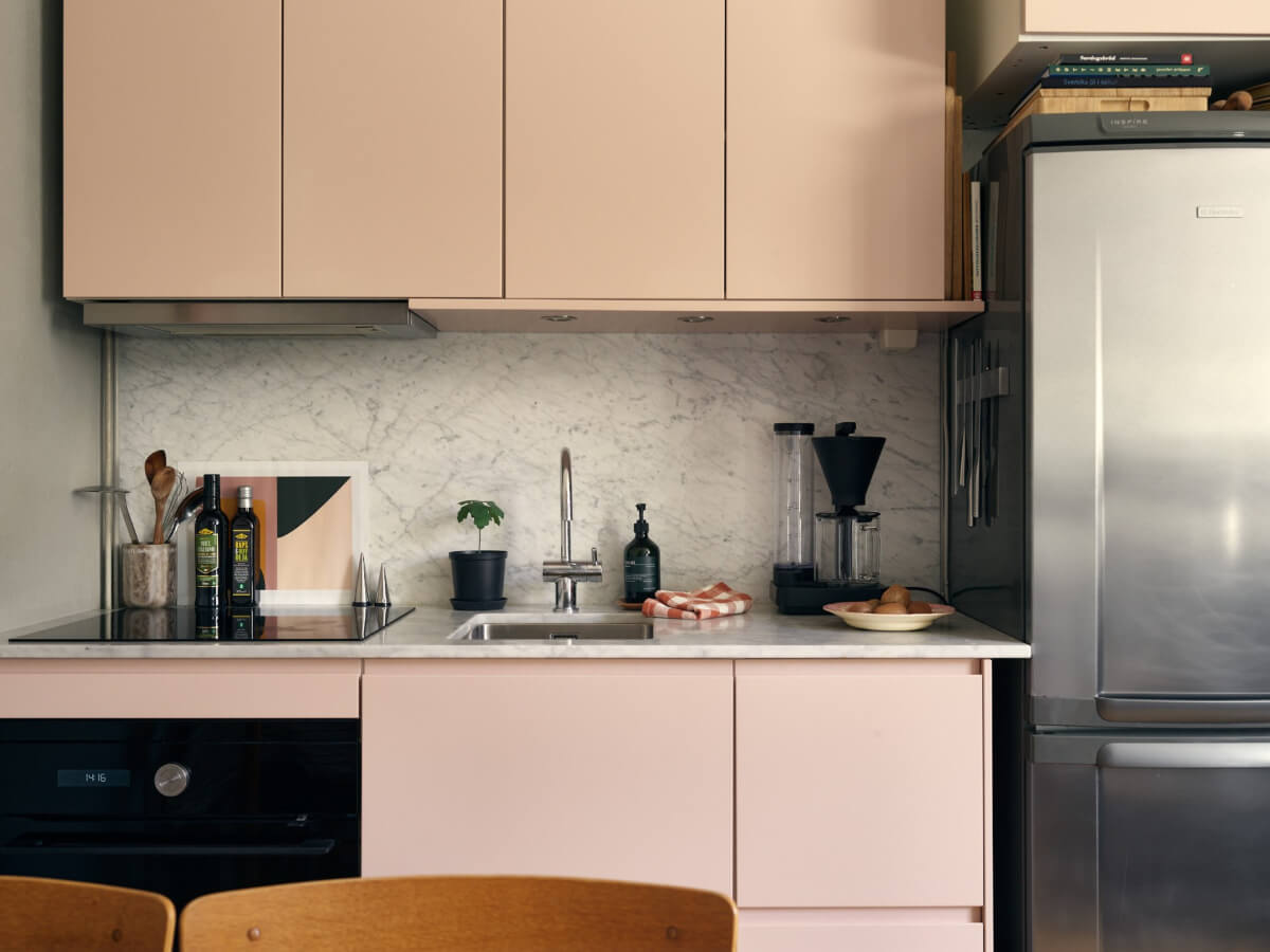 A Tiny Apartment with a Semi-Open Floorplan and a Pink Kitchen 10 pink kitchen marble countertop backsplash A Tiny Apartment with a Semi-Open Floorplan and a Pink Kitchen