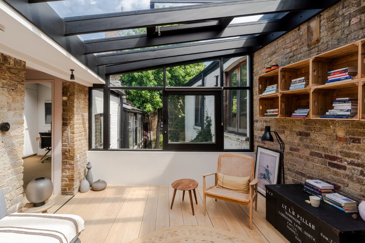 An Industrial Mews House with a Sebastian Cox deVOL Kitchen 15 sitting room exposed brick wall glass ceiling