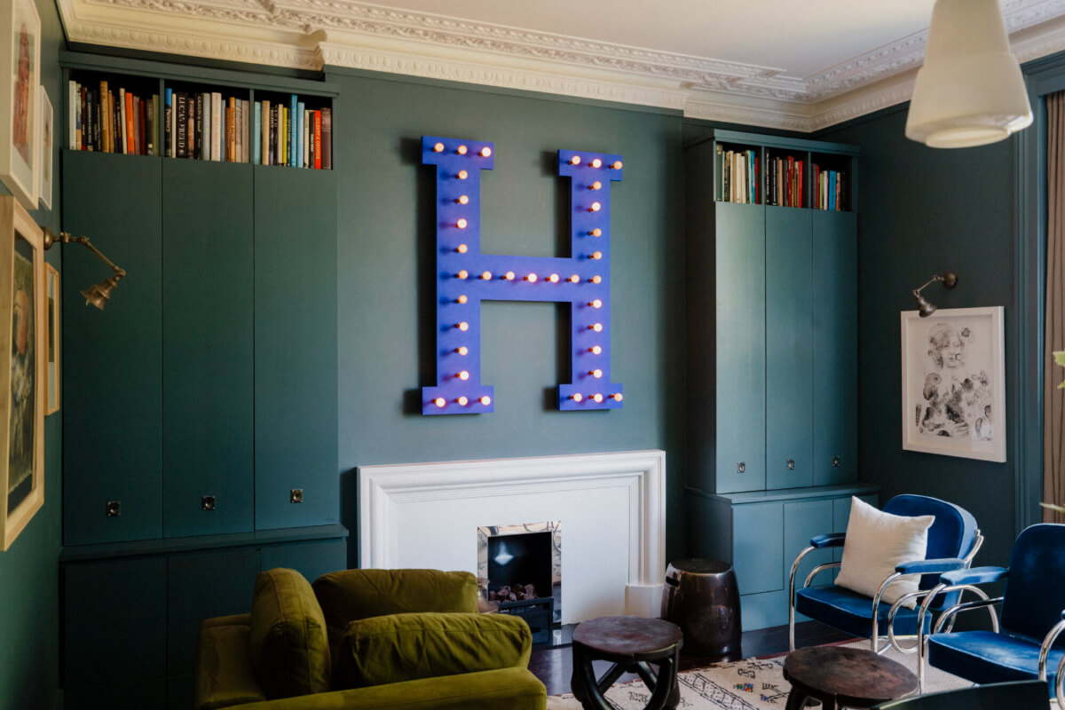 A Rich Color and Material Palette in a Small Victorian Apartment 13 sitting room with built-in cabinets and period stucco