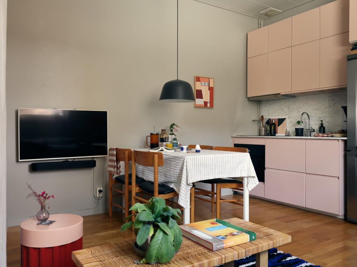 A Tiny Apartment with a Semi-Open Floorplan and a Pink Kitchen 6 small apartment living space light pink kitchen