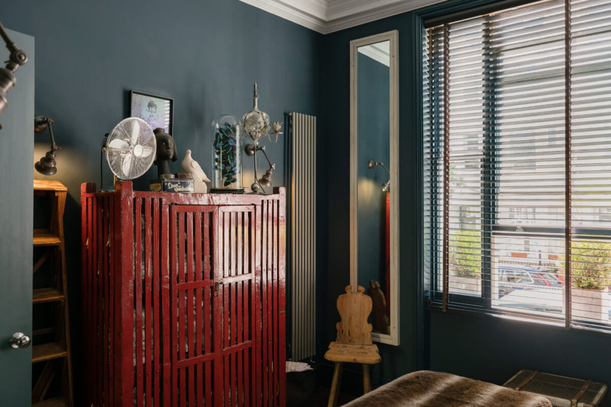 A Rich Color and Material Palette in a Small Victorian Apartment 16 small dark blue bedroom red wooden wardrobe