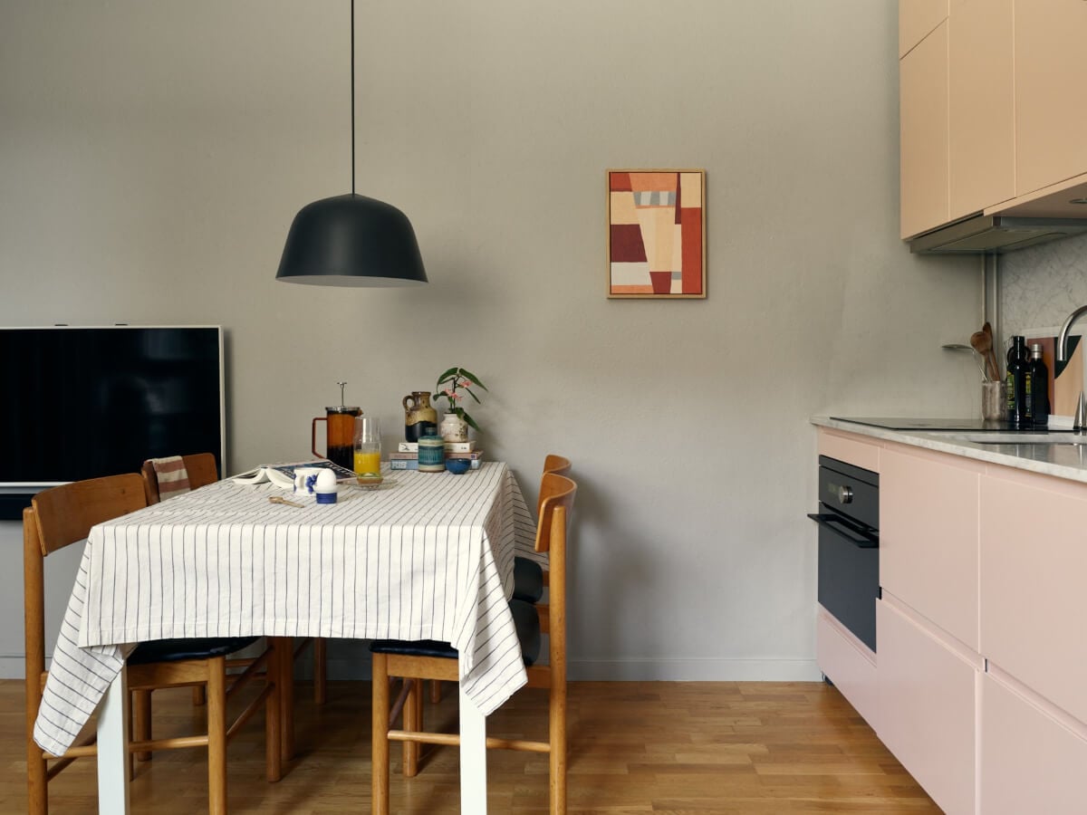 A Tiny Apartment with a Semi-Open Floorplan and a Pink Kitchen 11 small kitchen dining table