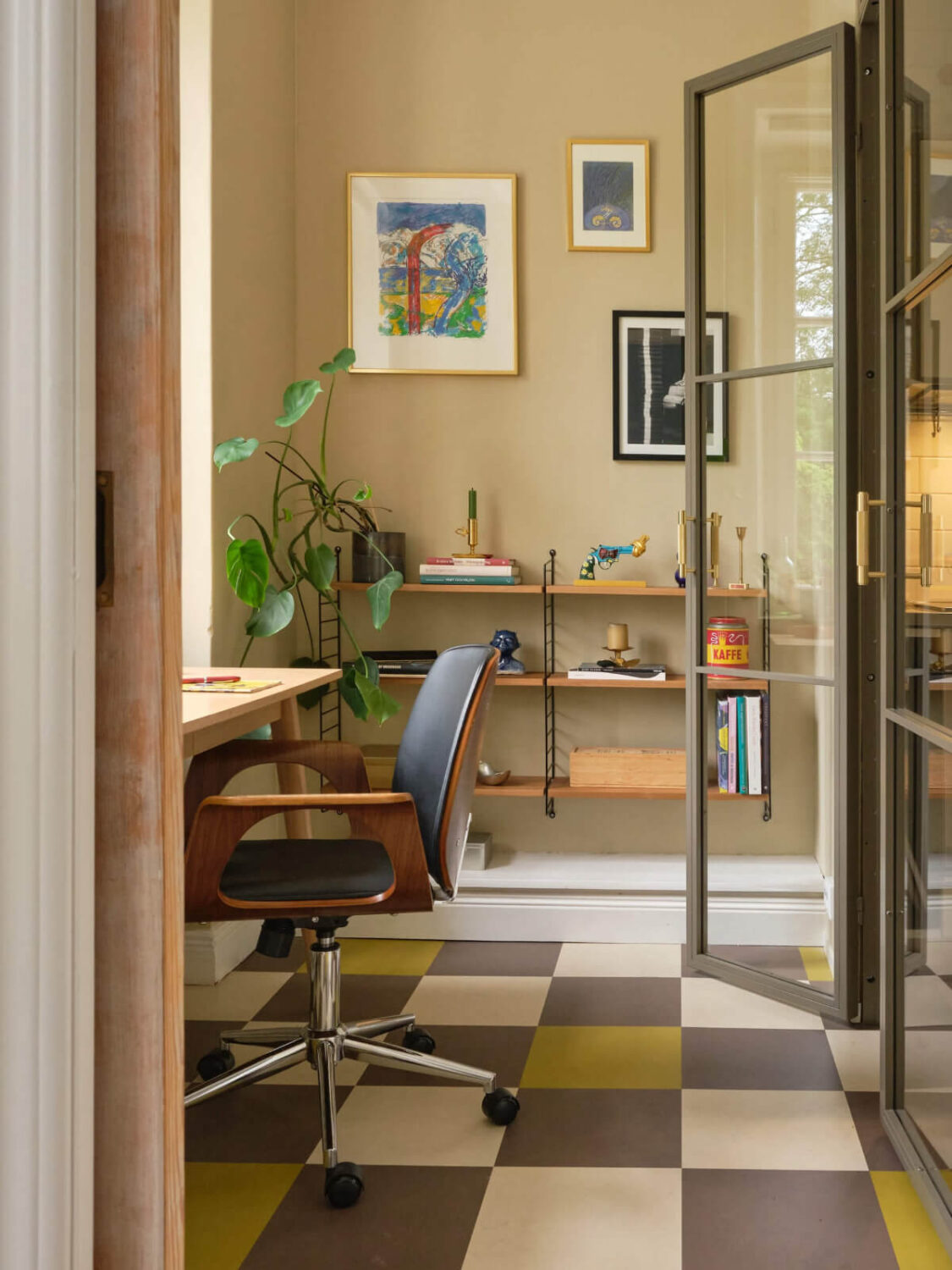 A Beautiful Color Palette and Historic Elements in a Stockholm Apartment 12 view into home office checkerboard floor