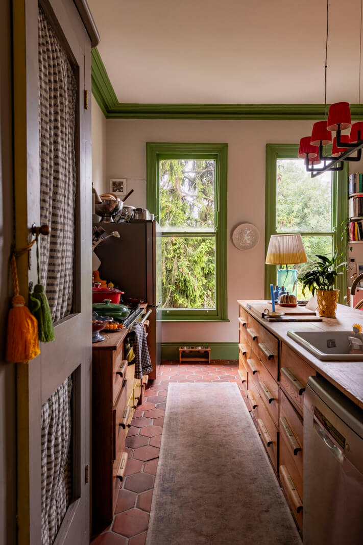 A Colorful Eclectic Victorian Maisonette Home in England 6 wooden kitchen terracotta floor tiles green window frames