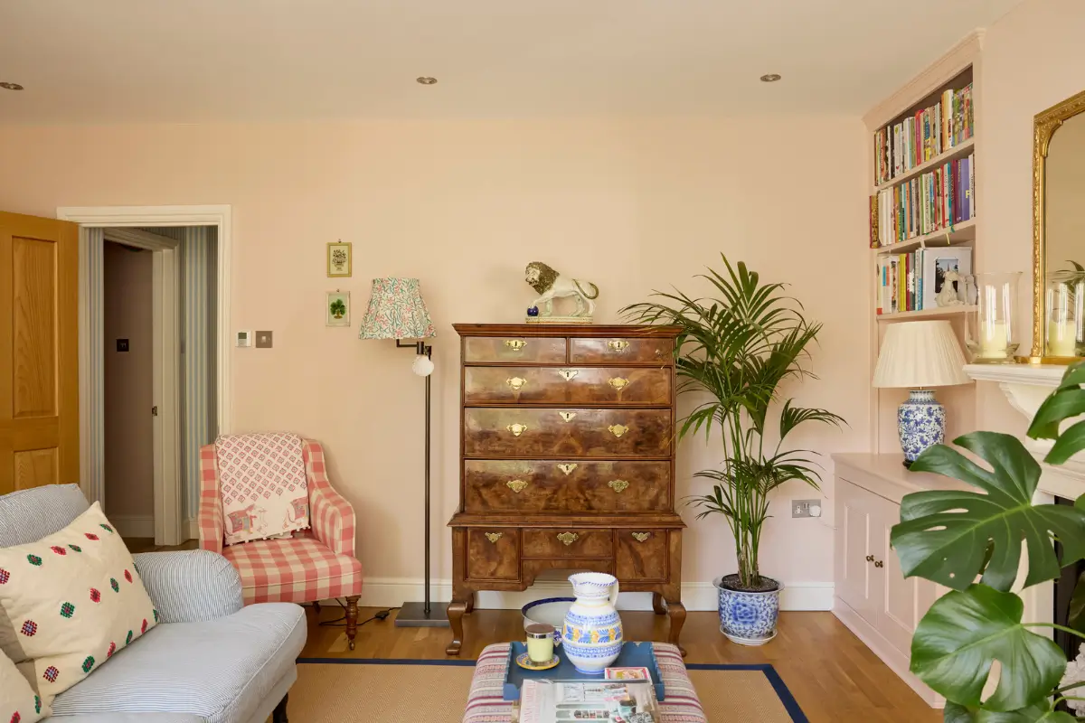 Pastel Hues in a Two-Bedroom Garden Apartment in West Kensington 3 antique cabinets pastel pink living room