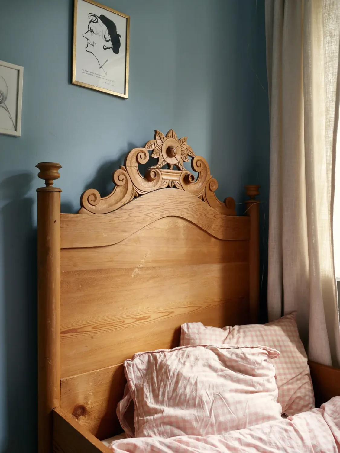 A Muted Color Palette in a Cozy 1920s Apartment in Stockholm 18 antique wooden bedframe