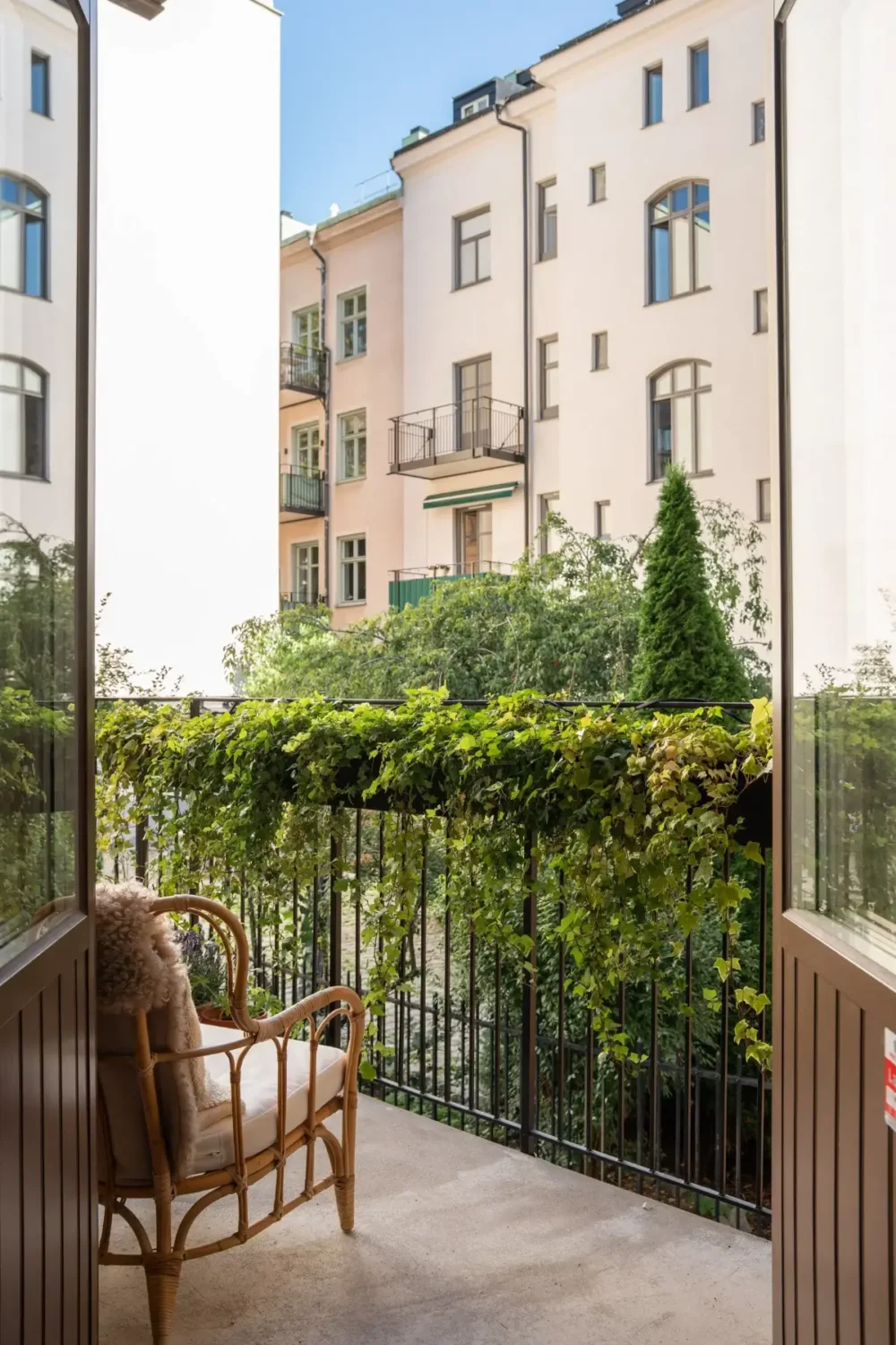 Arched Windows and Design Classics in a 19th Century Apartment 7 balcony with greenery