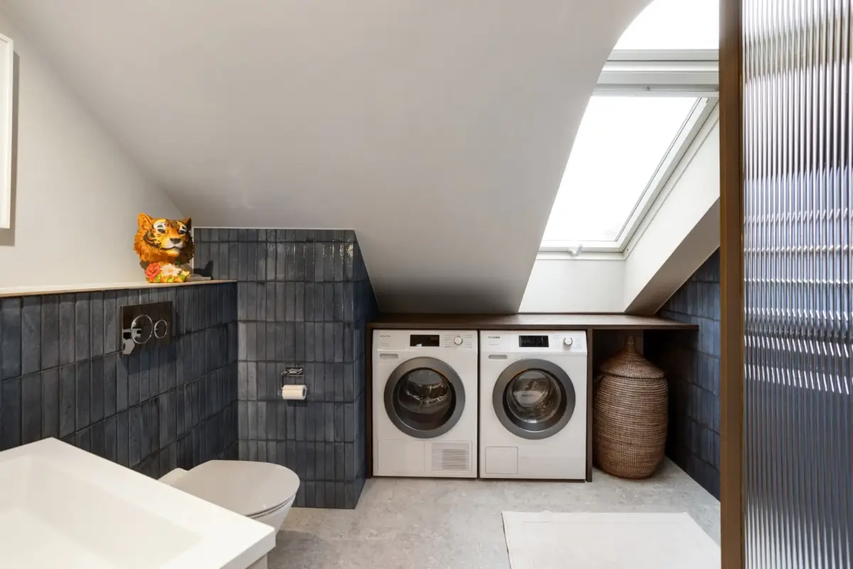 A Harmonious Color Palette in a Luxurious Stockholm Duplex Apartment 28 bathroom blue tiles and washer dryer