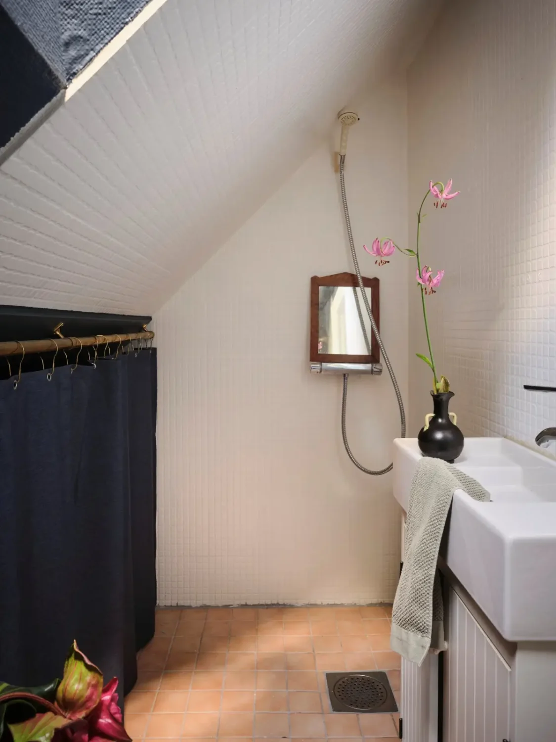 A Colorful Family Home in an Old Gardener's Cottage in Sweden 34 bathroom shower slanted ceiling