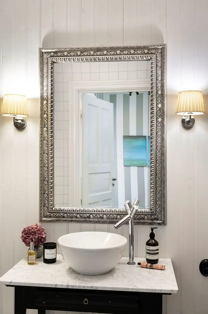 Scandinavian Design Meets The Hamptons in a Swedish Country House 33 bathroom sink on marble topped vanity