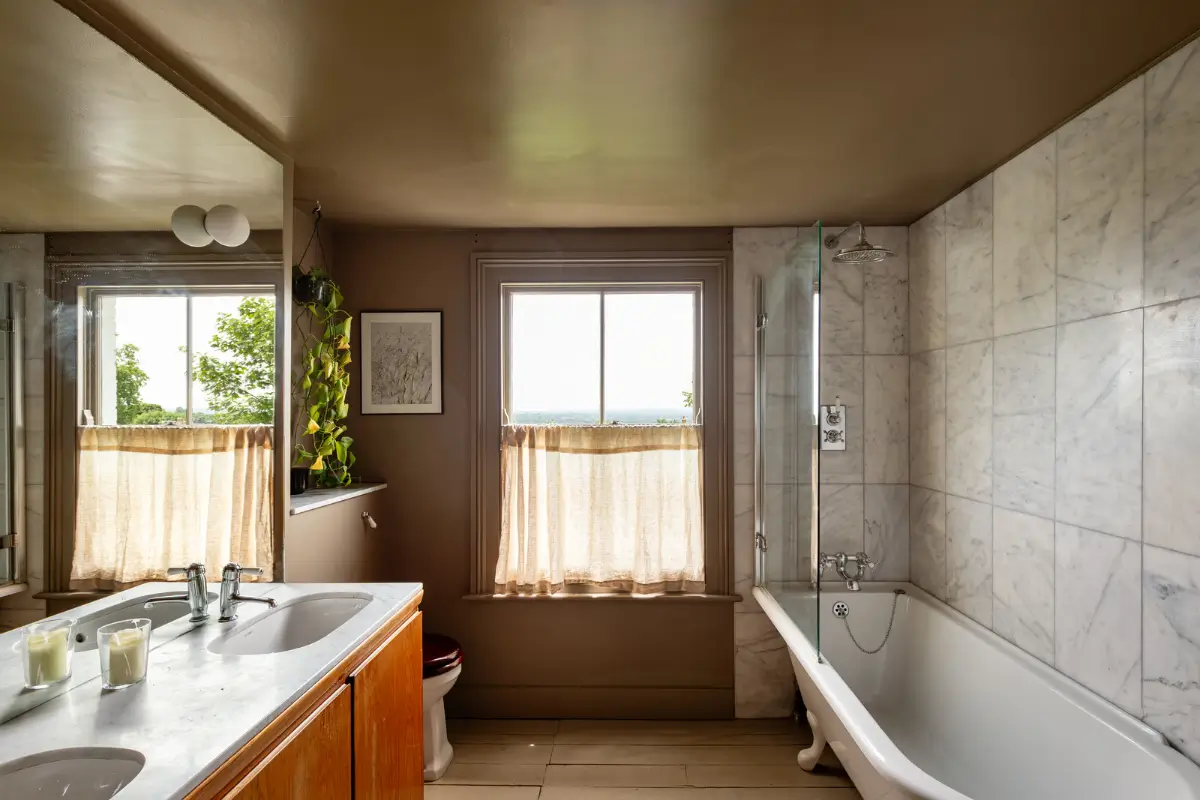 A Muted Color Palette and Original Details in a Victorian Terrace House 19 bathroom wooden floorboards marble tiles