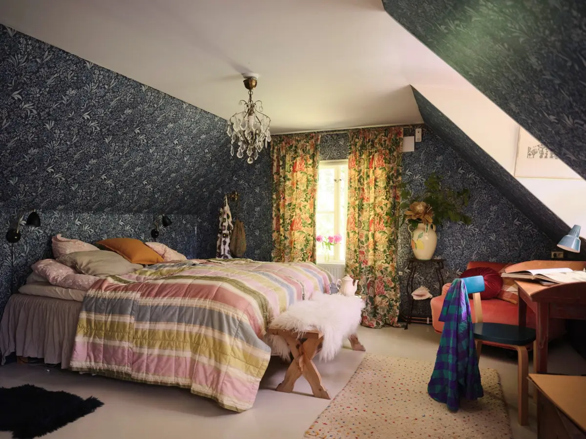 A Colorful Family Home in an Old Gardener's Cottage in Sweden 32 bedroom slanted ceilings dark blue borastapeter nocturne wallpaper nordroom