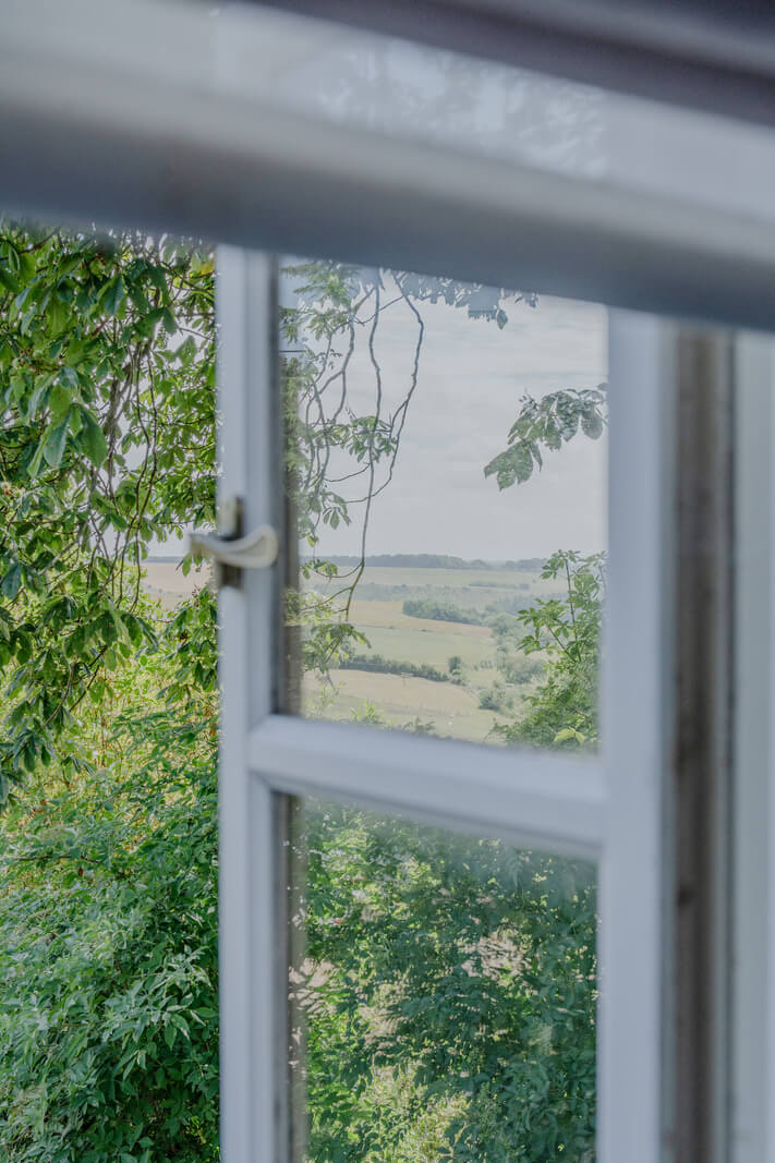 A Stone English Cottage with a Blue and Pink Kitchen 14 bedroom window view