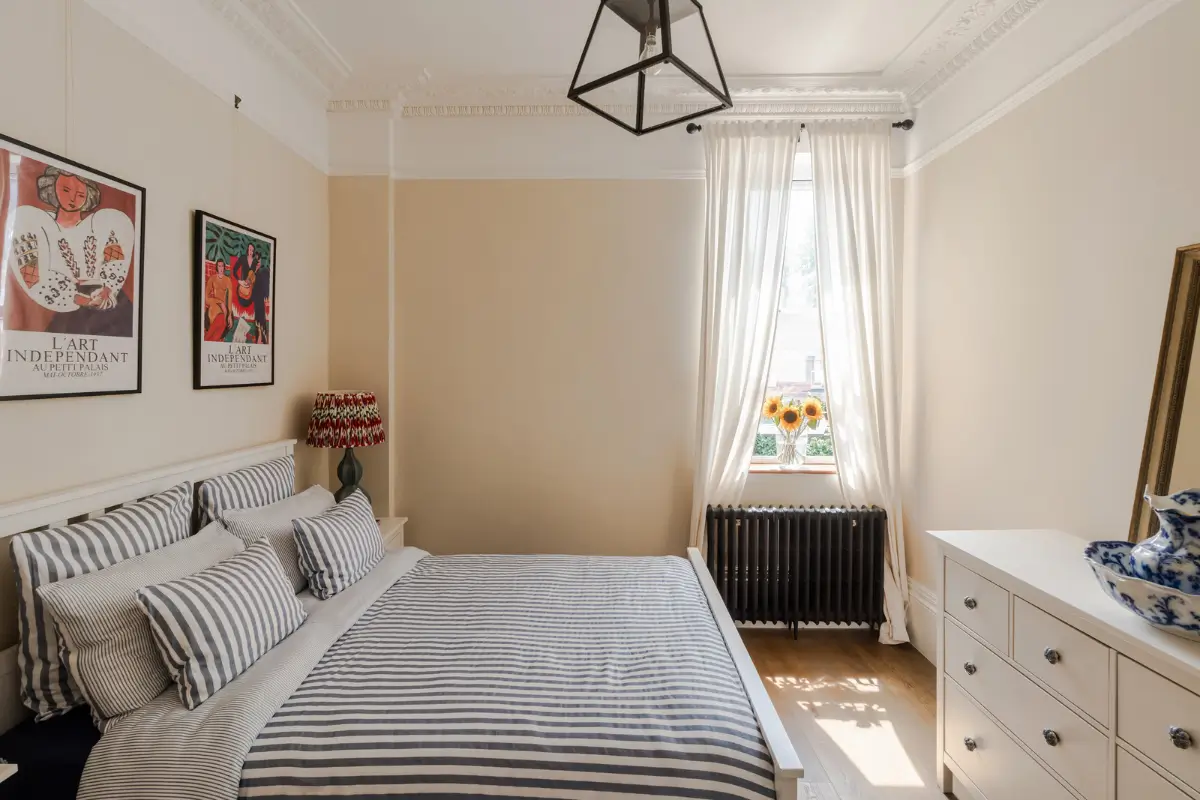 A Three-Bedroom Duplex Apartment with a Large Roof Terrace in London 11 beige bedroom striped bedding