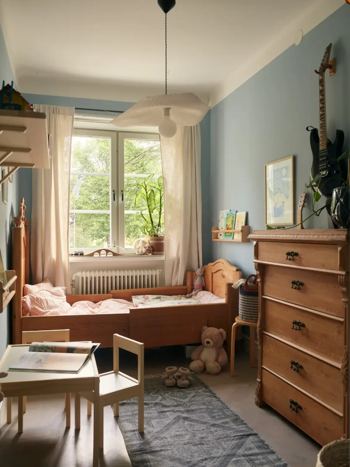 A Muted Color Palette in a Cozy 1920s Apartment in Stockholm 17 blue childrens bedroom with antique wooden furniture nordroom