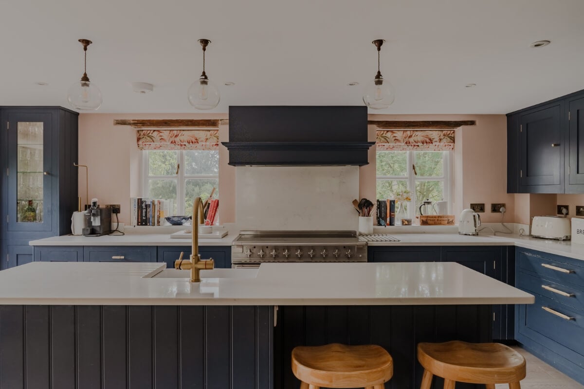 A Stone English Cottage with a Blue and Pink Kitchen 2 blue kitchen large island