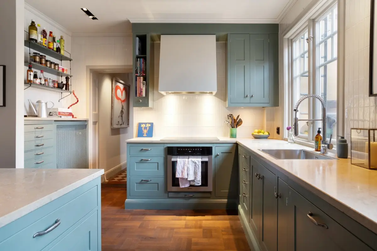 A Harmonious Color Palette in a Luxurious Stockholm Duplex Apartment 8 blue kitchen white backsplash tiles