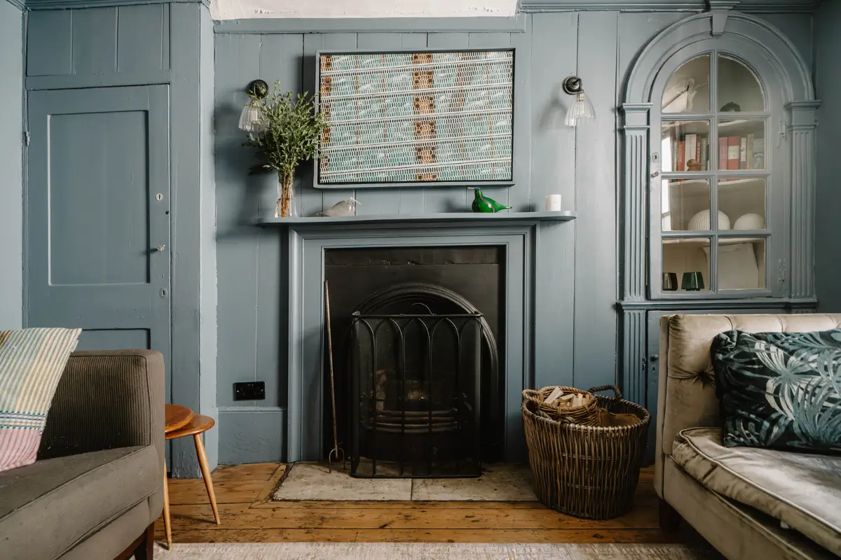 A 17th-Century Home with Original Elements in an English Seaside Town 5 blue paneled wall built-in cabinet with glass door