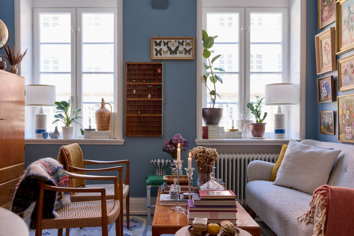 blue sitting room gallery wall with floral art