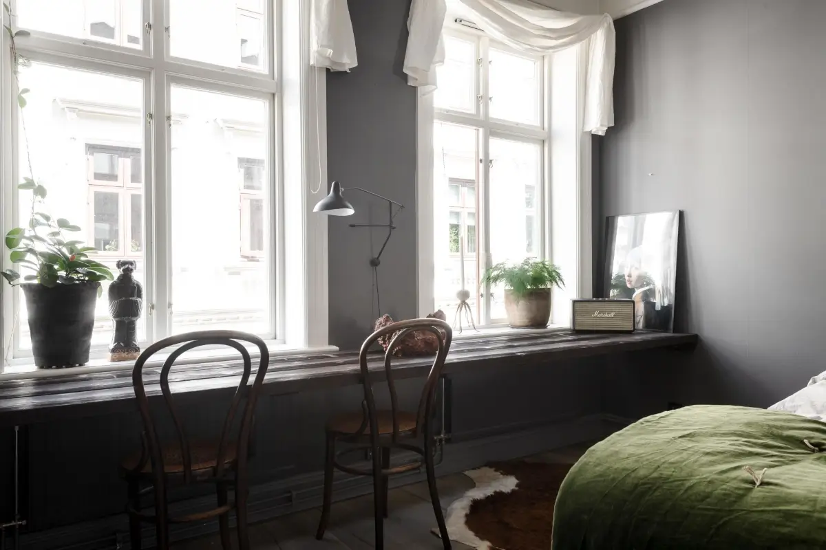 A Dark Gray Swedish Apartment with an Olive Green Kitchen 17 built-in desk under window