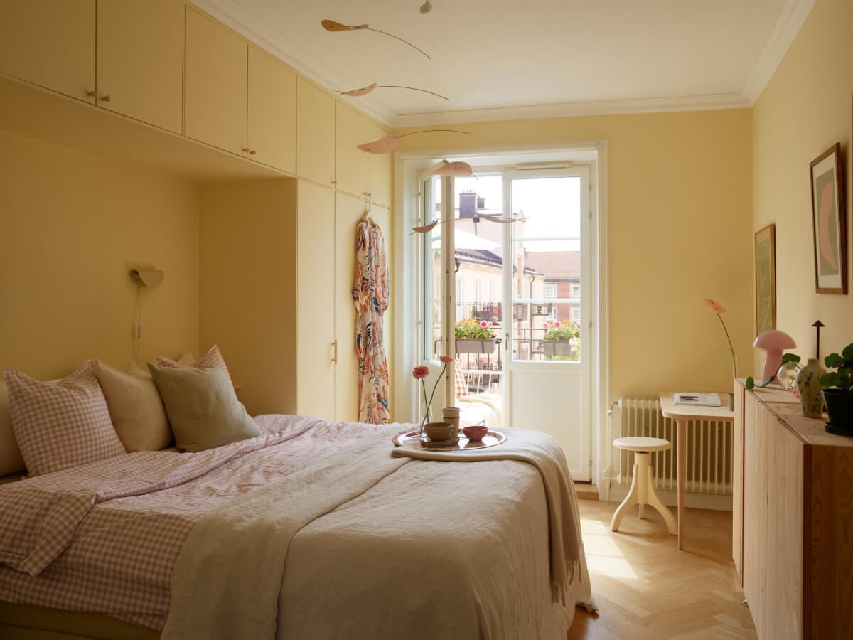 A Stockholm Apartment with a Butter-Yellow Bedroom 14 butter-yellow bedroom with built-in wardrobes nordroom