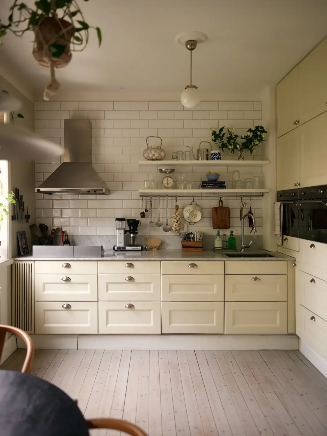 A Muted Color Palette in a Cozy 1920s Apartment in Stockholm 8 classic kitchen white backsplash tiles marble countertop nordroom
