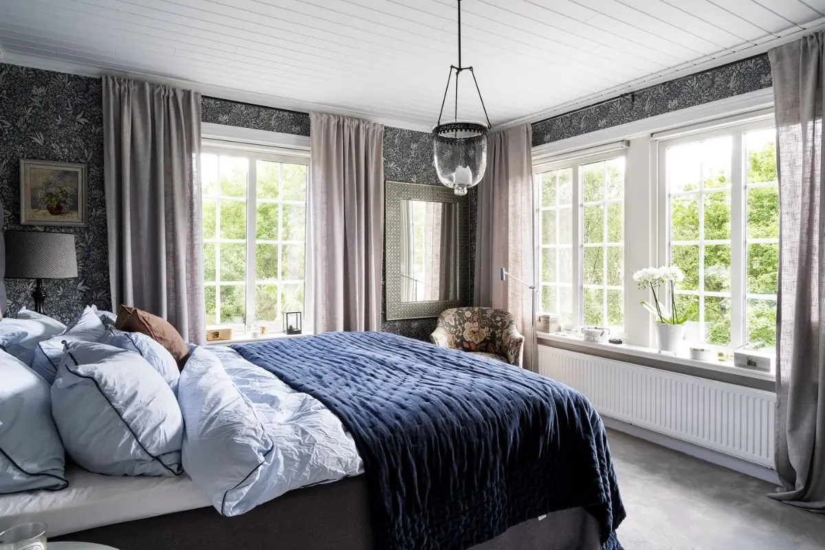 Scandinavian Design Meets The Hamptons in a Swedish Country House 42 corner bedroom large windows blue wallpaper nordroom