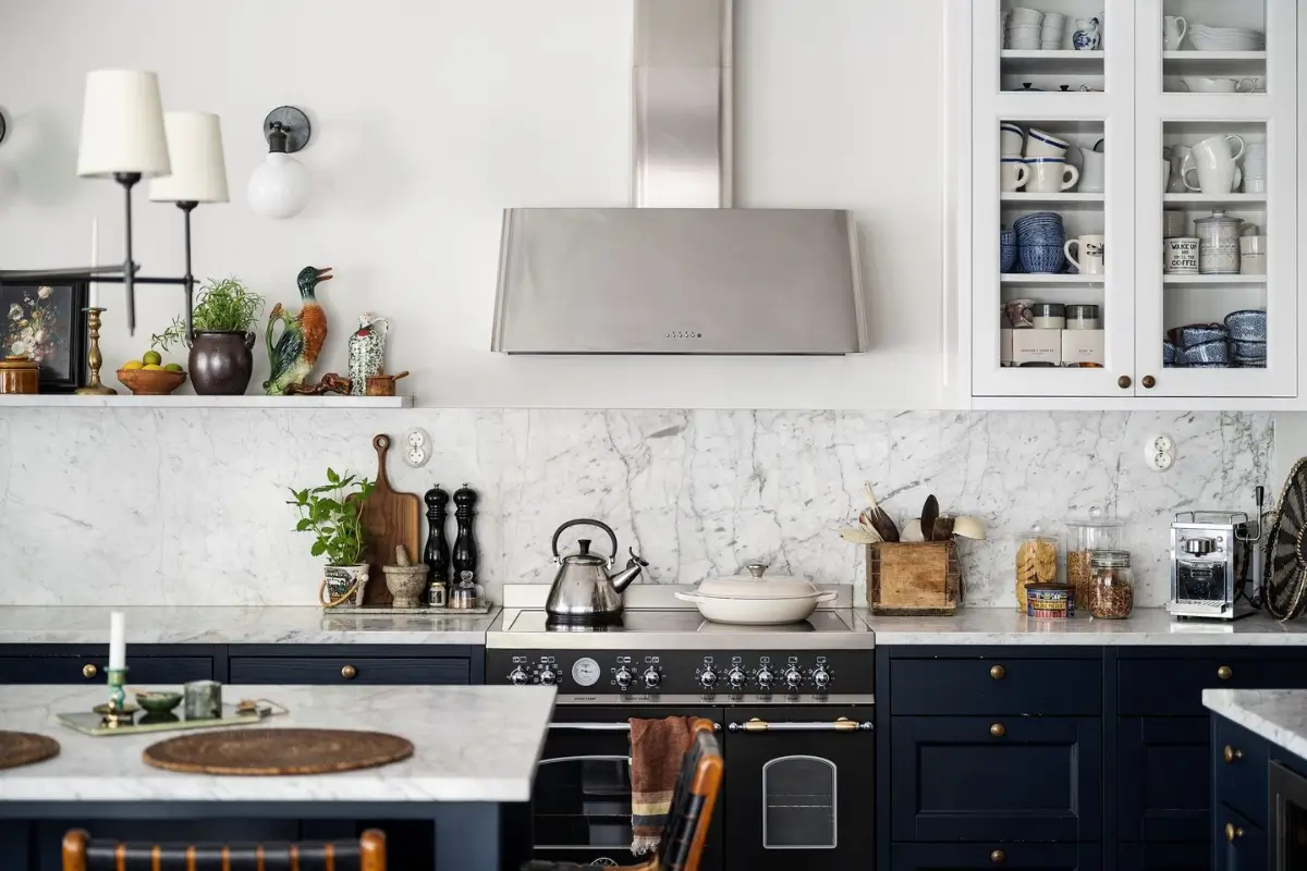 Scandinavian Design Meets The Hamptons in a Swedish Country House 14 dark blue kitchen cabinets glass-fronted white upper cabinet nordroom