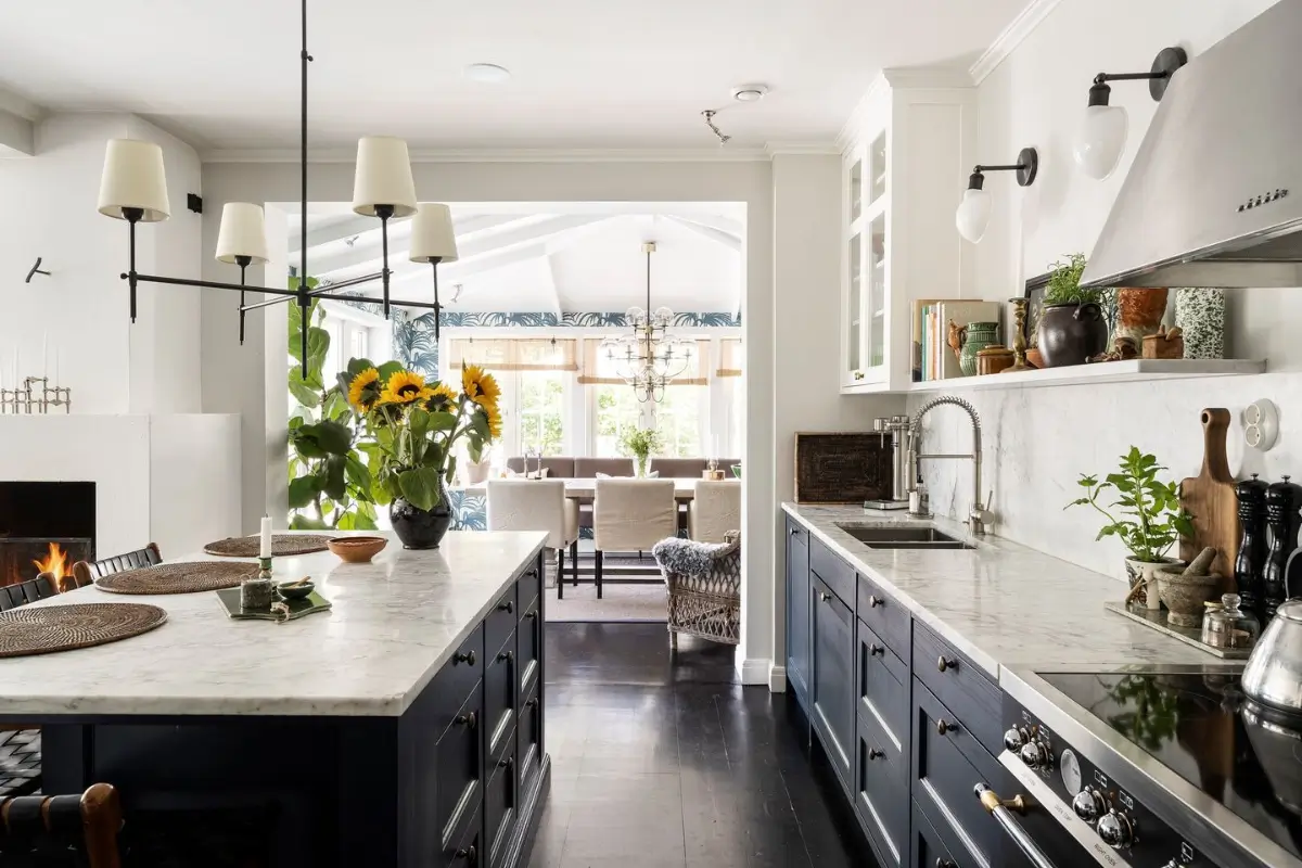 Scandinavian Design Meets The Hamptons in a Swedish Country House 22 dark blue kitchen with island marble countertops nordroom