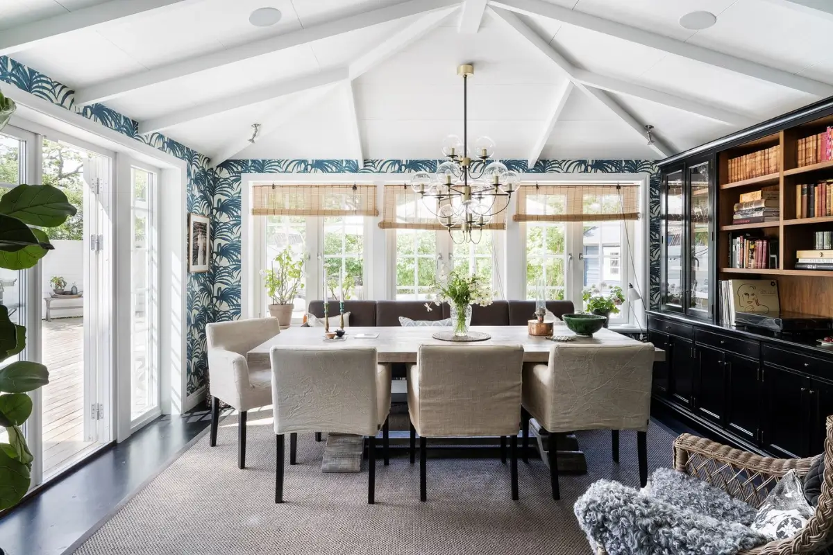 Scandinavian Design Meets The Hamptons in a Swedish Country House 23 dining room blue palm wallpaper large windows nordroom