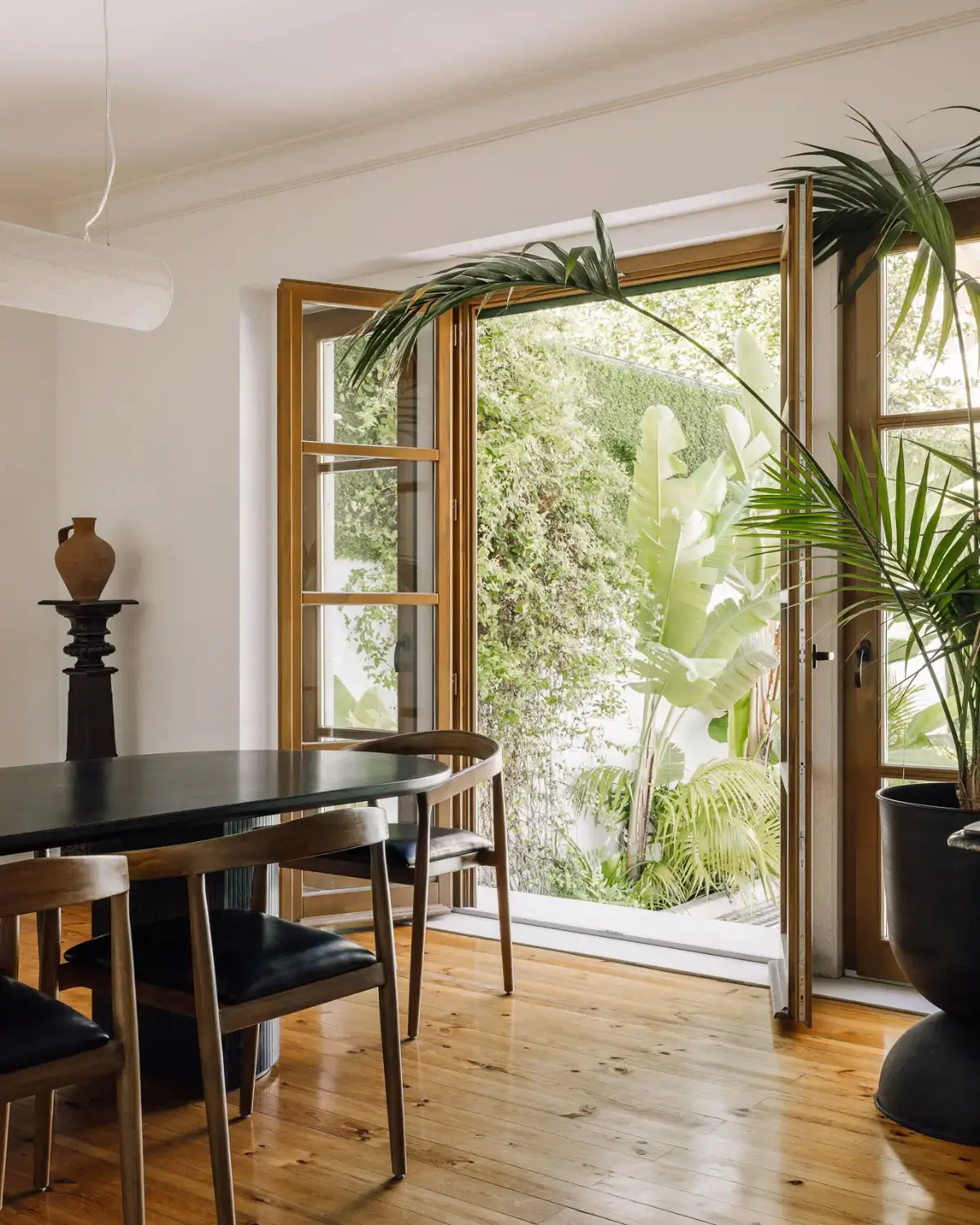 An Art Deco Villa with a Moroccan-Inspired Garden in Portugal 4 dining room glass wooden doors