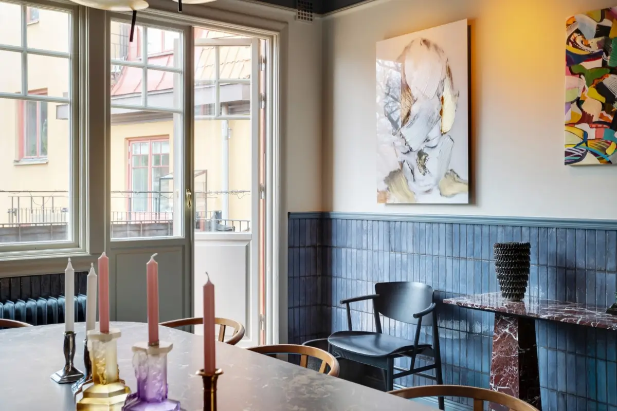 A Harmonious Color Palette in a Luxurious Stockholm Duplex Apartment 4 dining room half blue-tiled walls