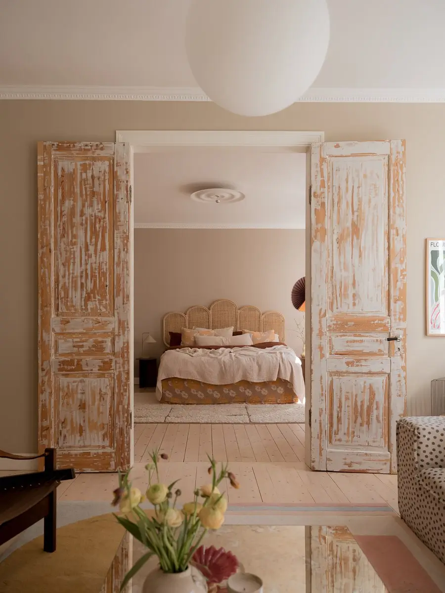 Neutral Shades and Period Elements in a Scandi Apartment 11 double wooden doors view into bedroom