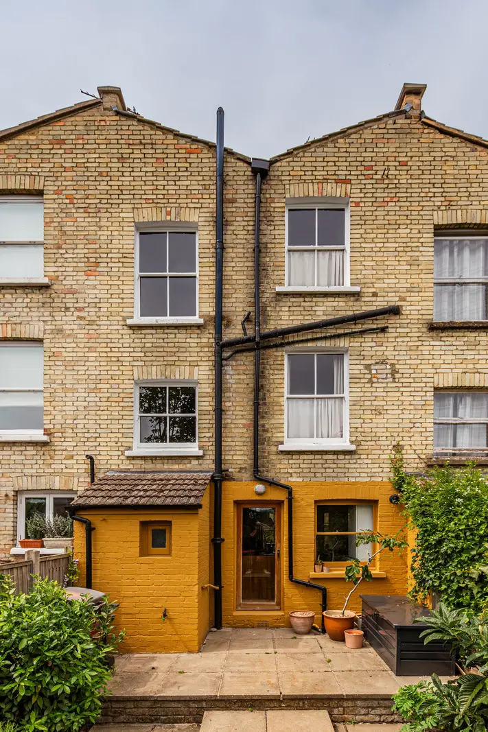 A Muted Color Palette and Original Details in a Victorian Terrace House 23 exterior ochre-painted brickwork