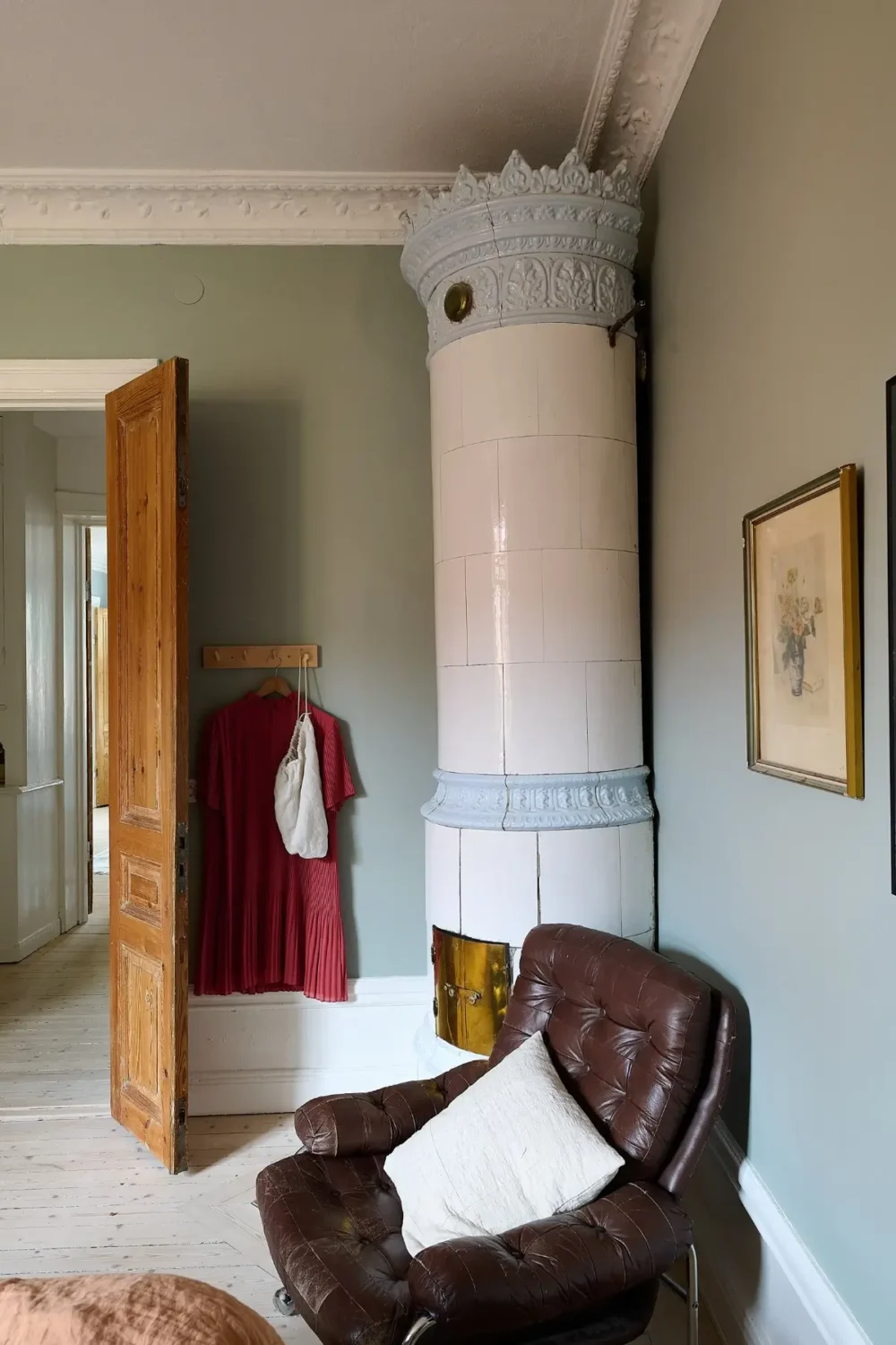 A Classic Stockholm Family Apartment with a Separate Studio 20 fireplace with pastel blue color accents