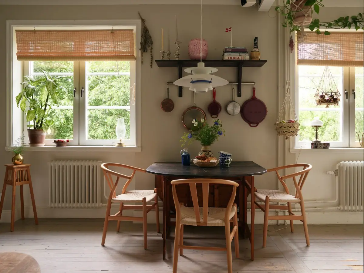 A Muted Color Palette in a Cozy 1920s Apartment in Stockholm 4 folding wooden dining table wishbone chairs nordroom