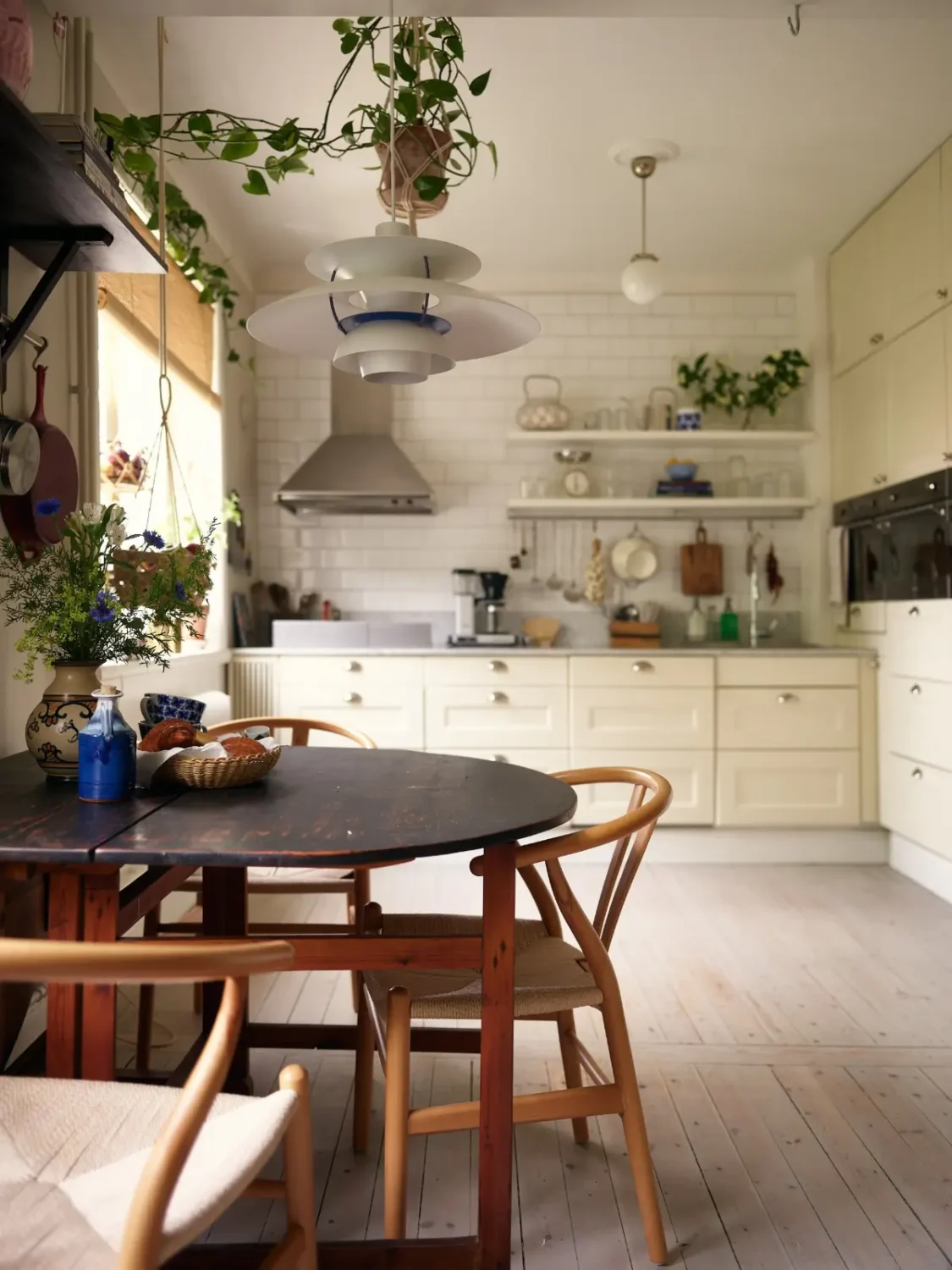 A Muted Color Palette in a Cozy 1920s Apartment in Stockholm 6 folding wooden table cream-colored kitchen