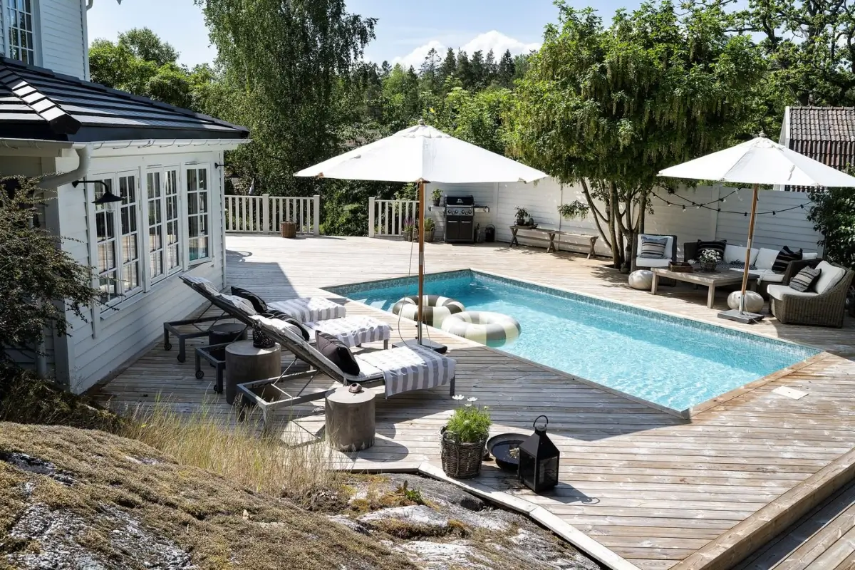 Scandinavian Design Meets The Hamptons in a Swedish Country House 62 garden wooden deck swimming pool
