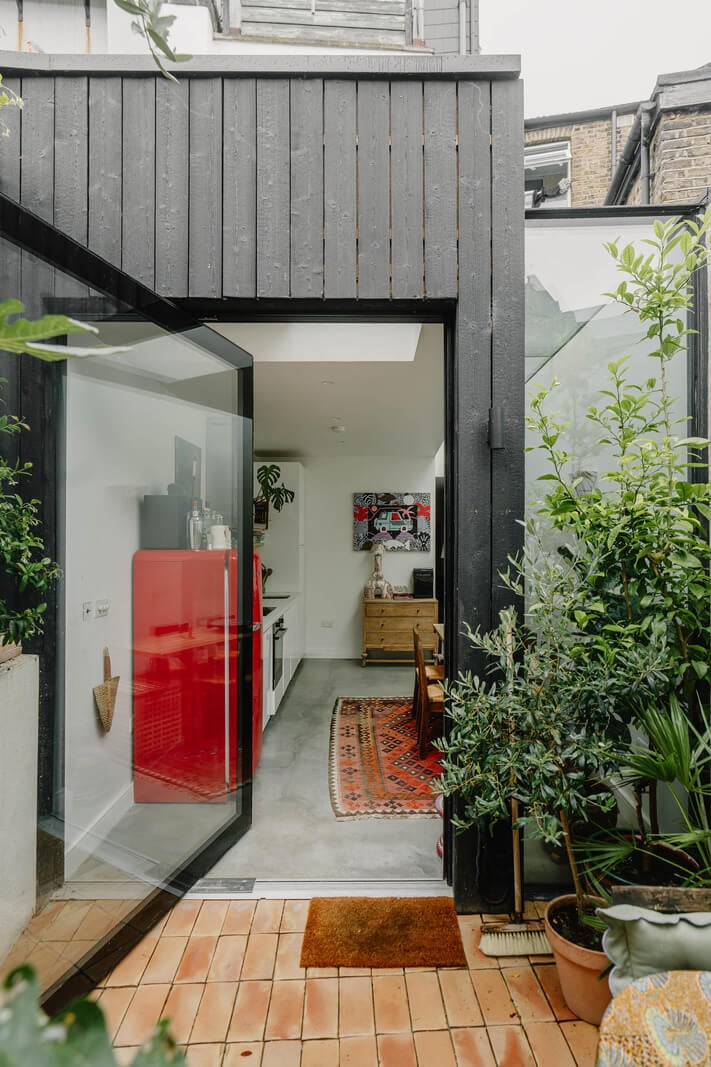 A Modern Ground-Floor Apartment with a Tiny Patio Garden 9 glass door extended modern kitchen space
