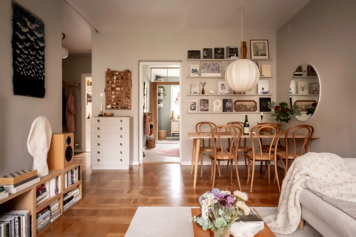 An Earthy Color Palette and Exposed Brick in a 1940s Apartment 2 gray living room parquet floor large dining table nordroom