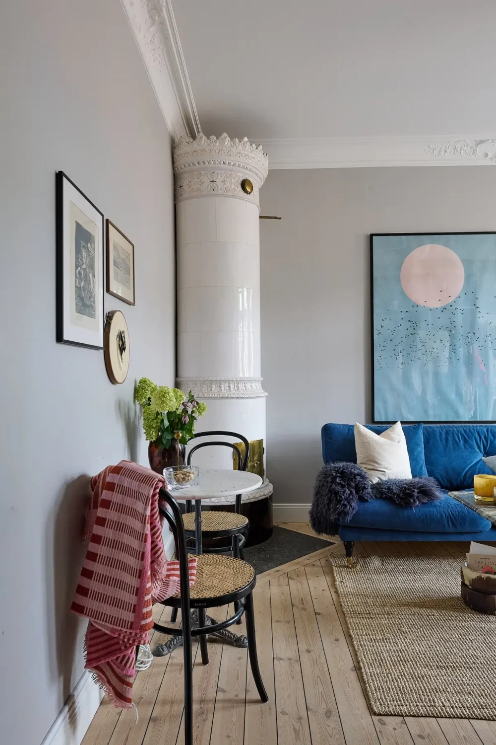 A Classic Stockholm Family Apartment with a Separate Studio 36 gray studio with blue sofa and fireplace