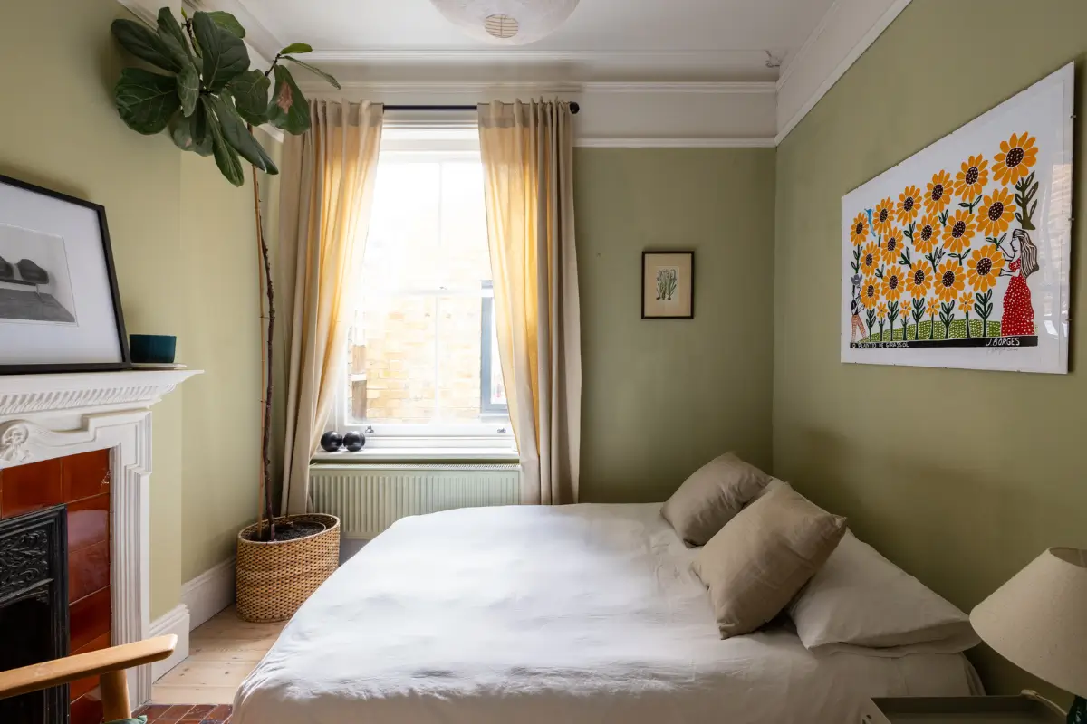 A Modern Extension and Period Details in a Ground Floor London Home 15 green bedroom with fireplace