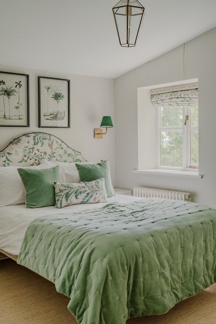 A Stone English Cottage with a Blue and Pink Kitchen 15 green floral headboard bedroom